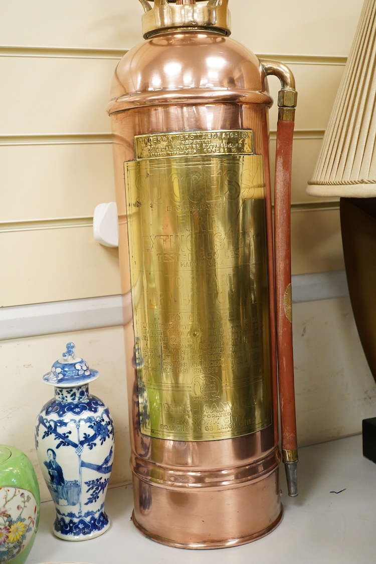A copper fire extinguisher mounted as a table lamp, overall 93cm high